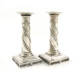 A pair of George III silver candlesticks, by John Winter and Co, Sheffield 1774, the columns with