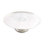 A George I silver footed waiter, by William Darker, London 1718, circular form, the centre with an