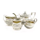 λA three-piece George III silver tea set, by Solomon Hougham, London 1809, rounded rectangular form,