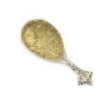 A Victorian cast silver caddy spoon, by George Adams, London 1848, gilded oval foliate bowl,