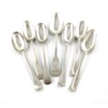 A collection of seven antique Irish silver tablespoons, comprising: five of Hanoverian form,