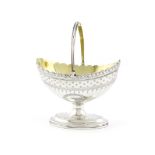 A George III silver swing-handled sugar basket, by Charles Hougham, London 1790, oval form, wavy-