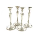 A matched set of four silver candlesticks, by Walker and Hall, Sheffield 1913/14, tapering