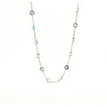 An aquamarine-set long chain, the square-shaped aquamarines set in yellow gold spectacle mounts on a