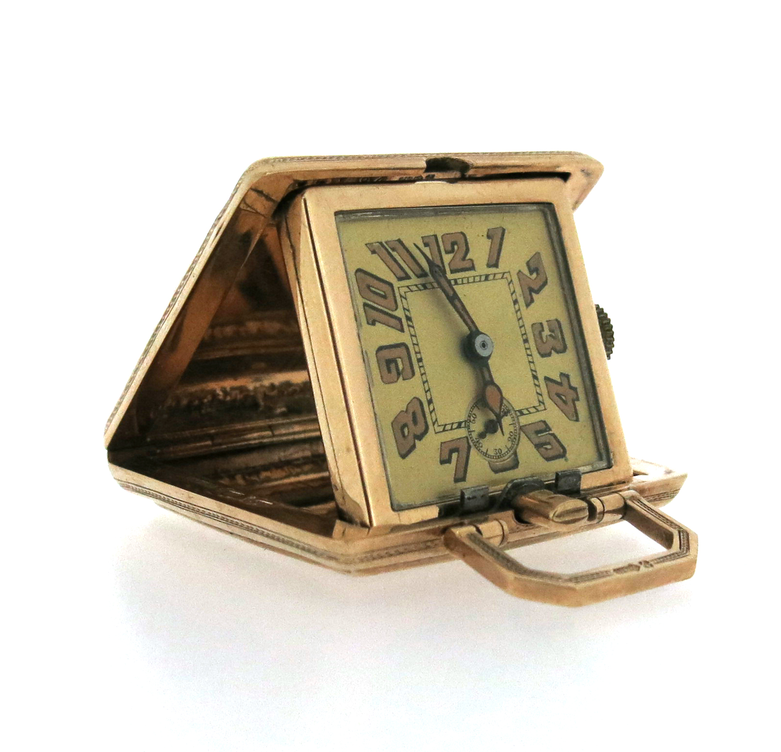 A 9ct gold travel clock, the square-shaped case with engraved decoration opens to reveal a square-
