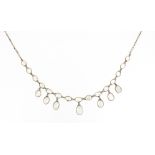 A moonstone fringe necklace, set in gold with oval-shaped moonstone cabochons on a fine-link gold