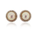 A pair of cultured mabé pearl and diamond cluster earrings, set in yellow gold, clip and post