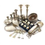 A mixed lot, comprising silver items: a sauce boat, a pair of candlesticks, another smaller pair