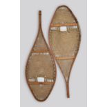 A pair of Alonquin snow shoes North America ash and sinew, each inscribed C. Harbord, 106cm long. (