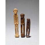 Three Dayak amulets Borneo standing figures, 6.5cm, 8.1cm and 10cm high. (3)