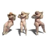 Three Hellenistic erotes as musicians circa 3rd century BC terracotta, each playing a lyre with