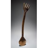 A Nigerian ladle with carved decoration and a prong terminal, 60.5cm long. Provenance The Fowler