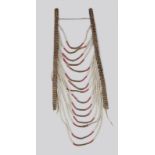 A Blackfoot loop necklace Plains with brass studded leather straps and cloth loops with white and