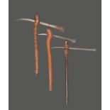 Three Zambia axes with linear decorated blades and shafts, with burnished areas, 62.5cm, 61.5cm