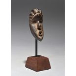 A Bassa passport mask Liberia with a ribbed coiffure and an open pouting mouth, 7.7cm high,