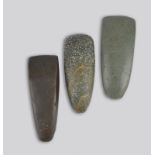 Three Melanesia adze blades greenstone and basalt, 12.7cm, 13.3cm and 14cm long. (3)