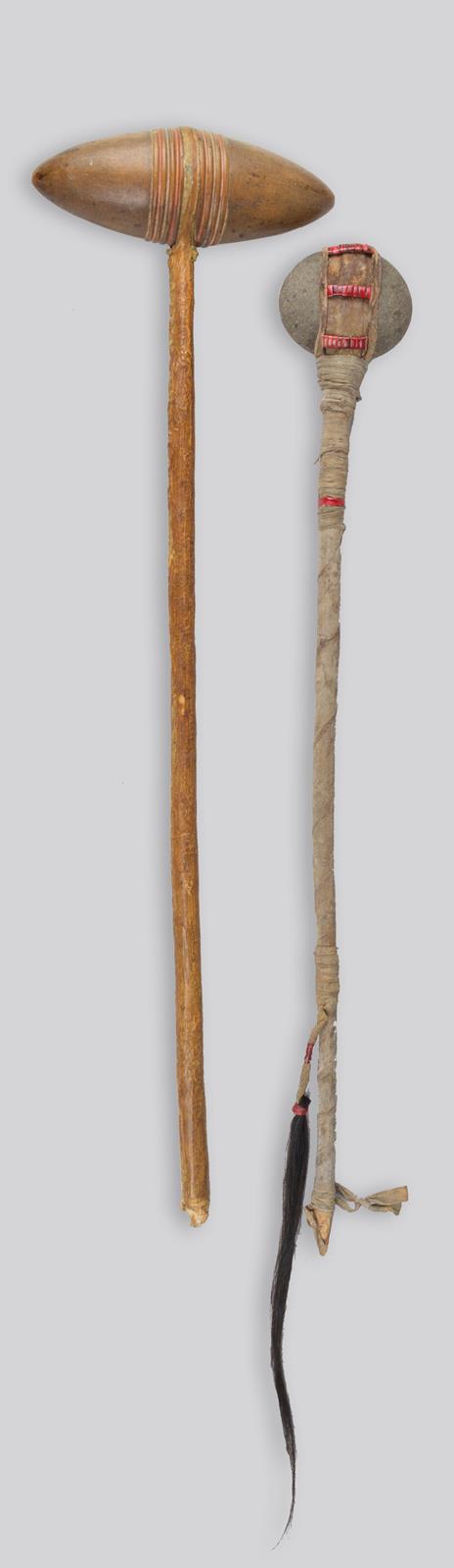 A Plains stone headed club ovoid with linear grooves and having red and blue pigment, the wood