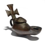 A Byzantine bronze oil lamp circa 5th - 6th century AD with a scallop shell hinged cover and a cross