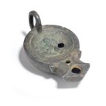 A Grand Tour Roman style oil lamp late 19th century bronze, the centre with a relief of Cupid, 8.5cm