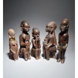 Five Kamba female figures Kenya four with infants and one drinking from a bowl, the highest 31cm. (