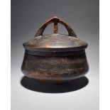 A Rotse bowl and cover Zambia with incised banded decoration and with an open finial cover, 27cm