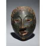 A Java mask Indonesia with carved and pigment decoration, the back inscribed R SR L, 1/09 10, 17.5cm