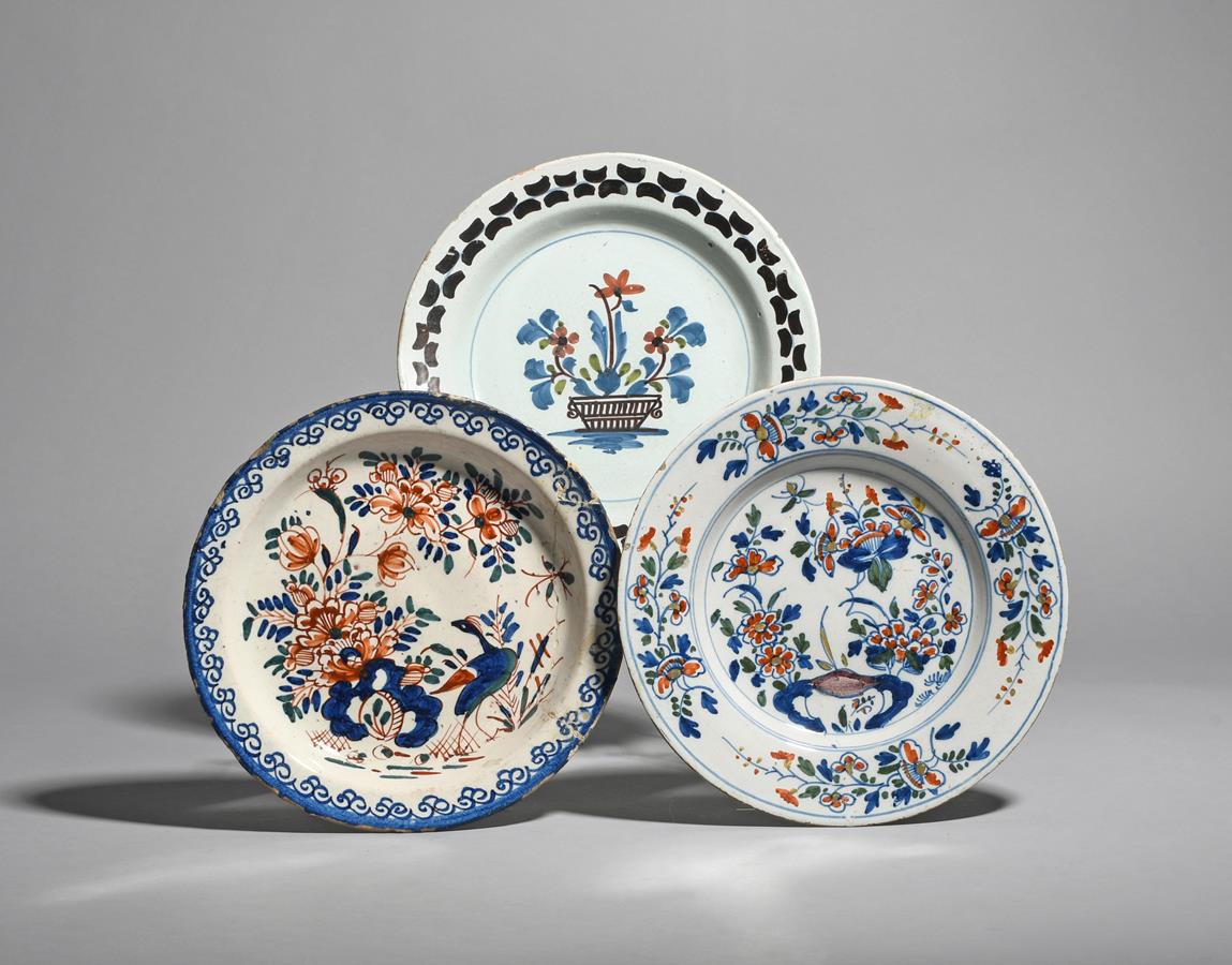 Three delftware plates c.1730-50, one probably Bristol and painted in blue, red and green with a