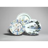 Three polychrome delftware plates c.1740-70, one painted with a Chinese figure holding out a leaf