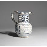 A delftware puzzle jug c.1740-60, probably Lambeth, the rounded body inscribed in blue with 'Here