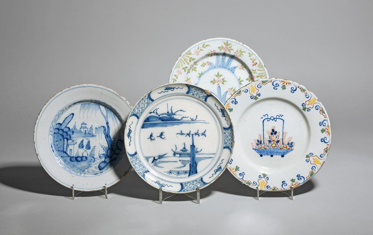 Four delftware plates c.1710-50, one of primitive shape and painted with figures in an island