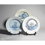 Three large Bristol delftware chargers .1760-70, one painted in blue with a tall pine tree flanked