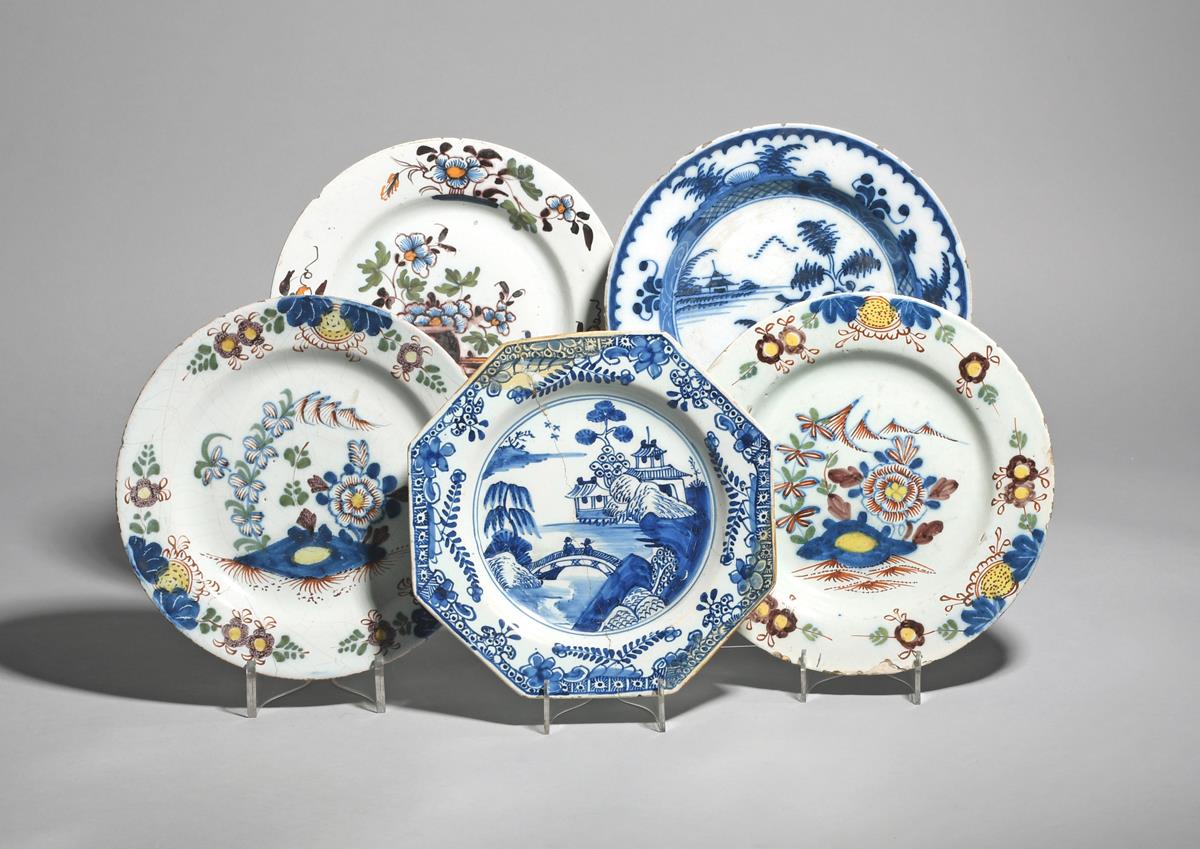 Five delftware plates mid 18th century, including a pair of plates painted in polychrome enamels