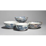 Four delftware slop bowls mid 18th century, the smaller Bristol and painted in blue with flowering