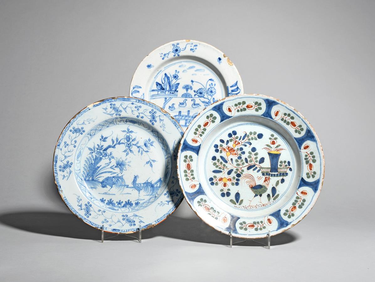 Two large delftware plates c.1730-40, one Liverpool and painted in blue with two cockerels beneath a