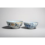 Two delftware bowls c.1760, the larger polychrome, the smaller painted in blue, each with the same