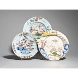 Three delftware plates c.1760, painted in polychrome enamels, two with cranes amidst flowering