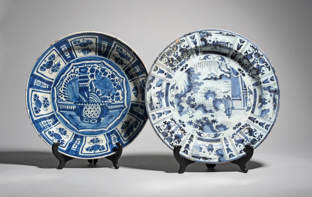 A Delft or German faïence charger c.1690, painted in blue with two Chinese figures in a garden