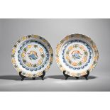 A pair of delftware polychrome chargers c.1730, possibly London, painted in blue, red, yellow and