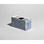 A delftware flower brick c.1750, the rectangular form painted in blue with a dense foliate design,