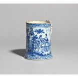 A delftware glass-bottomed mug c.1780-85, painted in blue with a maid pouring tea for a couple
