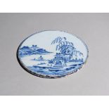 A rare delftware stand or trivet c.1720-40, the flat circular form painted in blue with figures in a