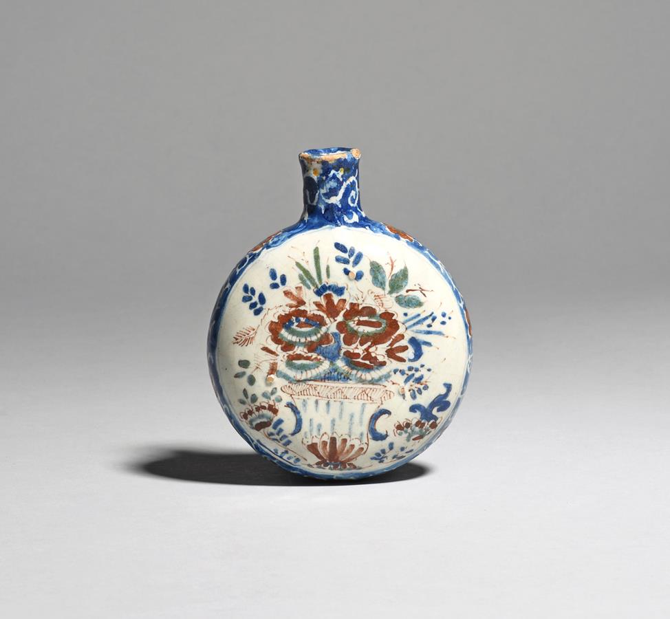 A small delftware spirit flask c.1730-50, probably English, the flattened circular form painted in