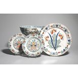 A near pair of Lambeth delftware plates mid 18th century, painted in bold polychrome enamels, each