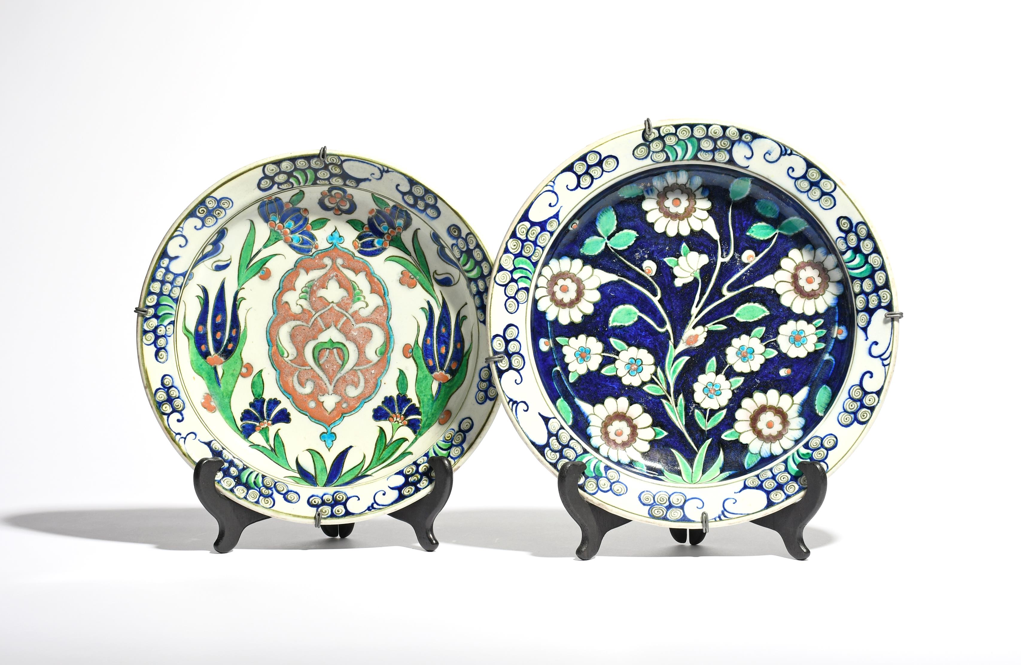 Two Kutahya large plates or dishes 19th century, painted in the Iznik manner, one with stylized