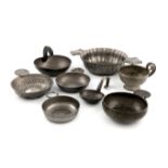 A collection of eight pewter wine tasters, including an early 19th century French one, maker's