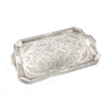 A two-handled metalware tray, unmarked, possibly middle Eastern, rectangular form, canted corners,