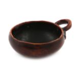 A late 18th century French treen wine taster, circular form, ring handle, with stylised supports,