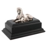 A silver model of a Sphinx, maker's mark of DRT, Birmingham, date letter worn, mounted on a black