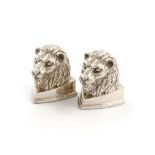 By Jocelyn Burton, a pair of modern cast silver menu card holders, London 1991, modelled as lion