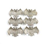 A set of six metalware wine labels, unmarked, probably Colonial, modelled as bats with out-stretched